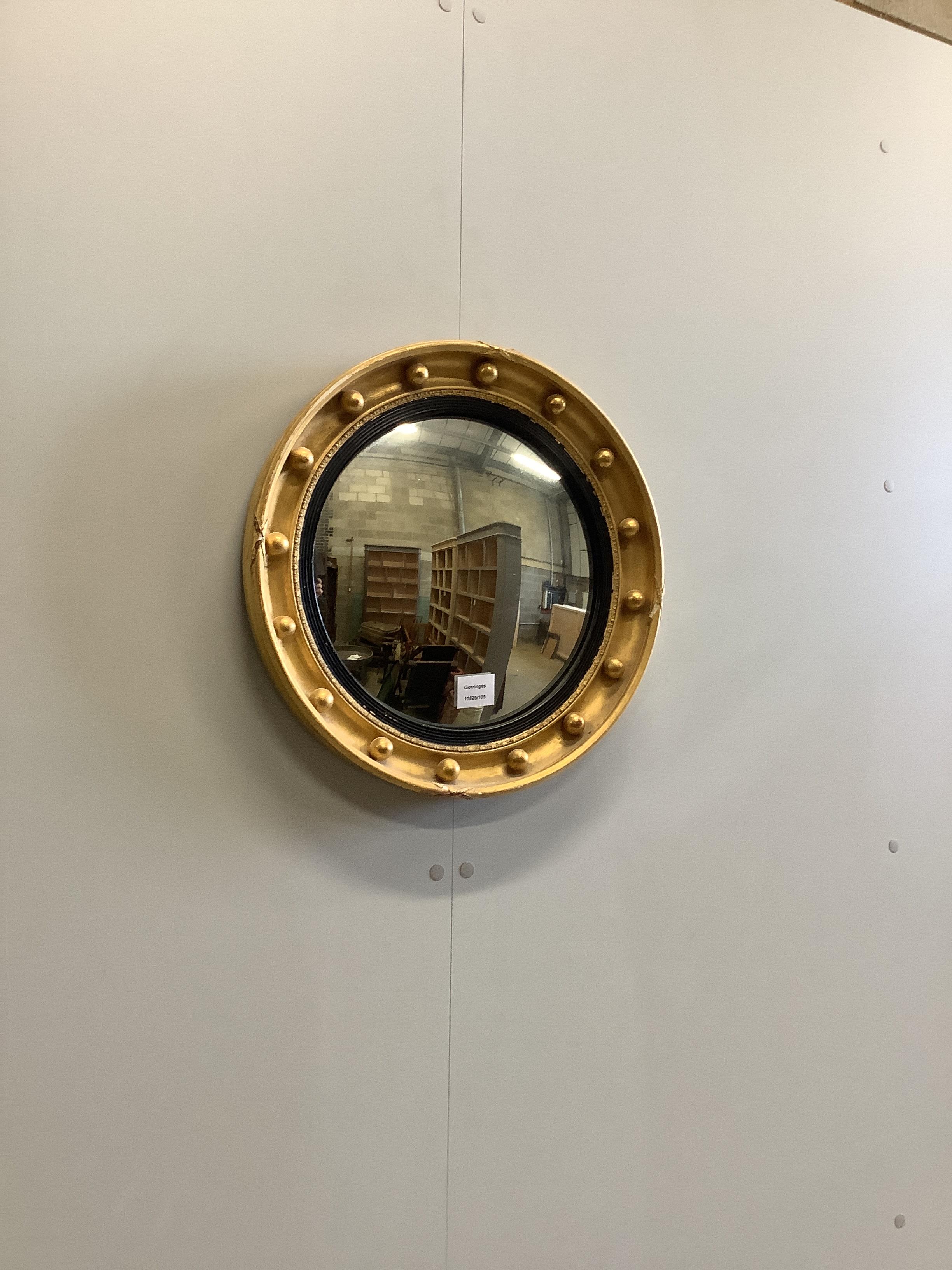 A Regency style circular giltwood and composition convex wall mirror, diameter 44cm